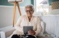 Senior woman using digital tablet at home